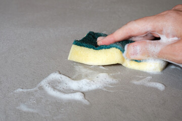 hand cleaning on a cement floor with a sponge and foam on a concrete floor, wet waterproof cement...