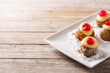 Traditional Italian Zeppole pastry on wooden table.Copy space
