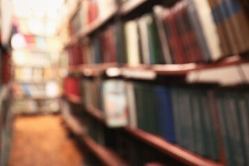 Blurred view of books on shelves in library