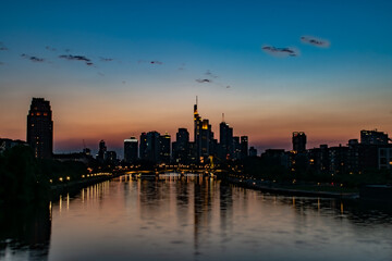 Fototapeta na wymiar Frankfurt am Main Skyscraper view Sunset and Sunrise river finance city twilight river skyscrapers sunset sunrise reflected reflection water