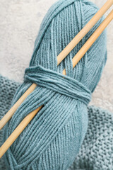 Knitting yarn and needles on grunge background, closeup
