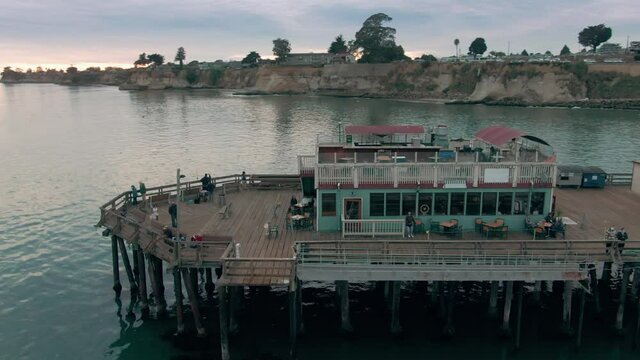 Aerial: Capitola wharf, cliff and beach, Santa Cruz, USA