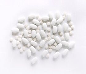 Fototapeta na wymiar White pills on a White background. Healthcare and medicine. 