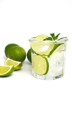 Glass of water with lime, ice and mint. Isolated on white background.