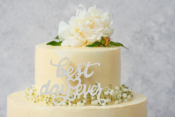 Delicious wedding cake and text BEST DAY EVER on light background, closeup