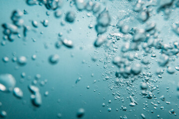 Underwater View of Bubbles In Deep Blue Ocean. Close Up Water. Background