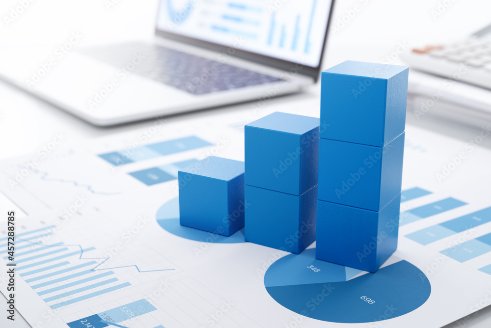 Aufkleber business growth and analysis.　many graphs on reports and laptop display.
