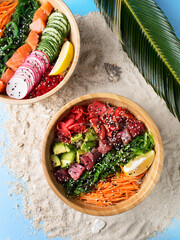 Hawaiian cuisine. Tropical food with fish, vegetables. Lunch on the beach. An exotic dish. Poke...