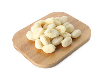Wooden board with raw gnocchi on white background