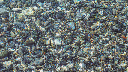 Stones at the bottom of the sea in the clear water of Crete


