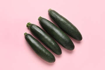 Fresh zucchini squashes on color background