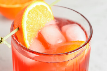 Glass of tasty Negroni cocktail on light background, closeup