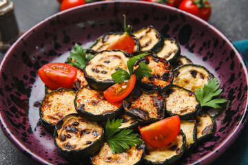 Plate with tasty grilled zucchini on dark background, closeup