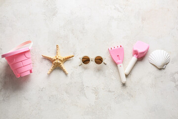 Set of beach accessories for children on light background