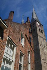Fototapeta na wymiar The Saint Nicholas Church in Deventer, the Netherlands, against a blue sky with fluffy clouds