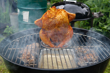 Chicken carcass baked on a kettle grill - 457292763