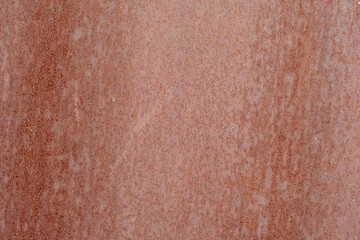 Rust on painted metal when exposed to the environment.