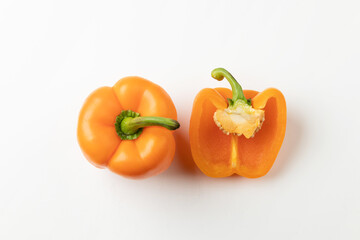 One a half orange bell peppers isolated on white background, top view
