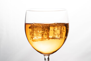 Homemade Aperol spritz. Orange sparkling cocktail in a glass upfront the light. Ice in a cocktail