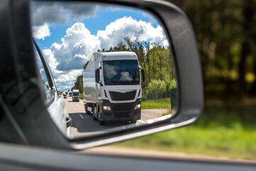 travel europe and germany - truck traffic on highways, truck in the back mirror