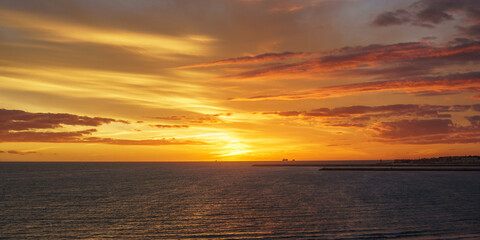 ships sailing on the horizon with sunset