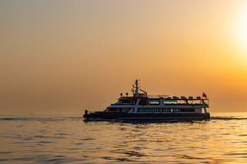 Fototapeta na wymiar Ferry boat in Marmara sea near Istanbul coast. Sunset time