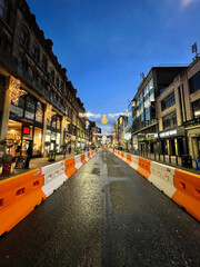 Fototapeta premium City street at night with buildings and moving traffic. Taken in Manchester England. 