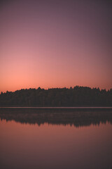 Calm lake water with pink sunset