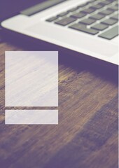 White banner with copy space against close up of a laptop on wooden table