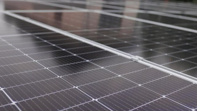 Solar panels close-up. Solar panels slow motion. Solar panels moving shot. Close-up of modern photovoltaic solar battery panels. Ecology and environment protection concept. Renewable green energy.