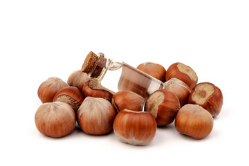 Hazelnut oil in glass bottle isolated on white background. Hazelnut background, healty food