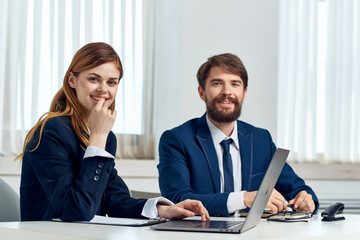 colleagues talking at the table in front of laptop team technology