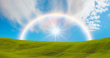 Naklejka premium Beautiful landscape with green grass field amazing rainbow in the background 