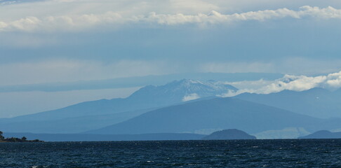 Landscape layers on a cloudy day, with Mount Ruapehu in the distance, looking over Lake Taupo, from Taupo, New Zealand