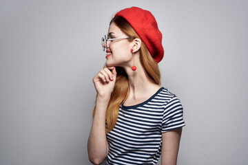 cheerful woman wearing a red hat makeup fashion posing