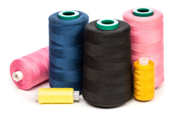 Sewing thread spools of various colors isolated on white background