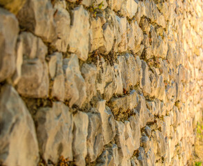 Stone fence or wall. Close up. Selective focus