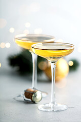 Two champagne glasses,cork and Christmas decorations selective focus