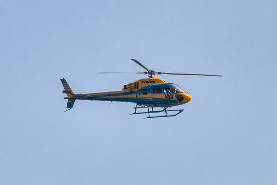 Huelva, Spain - July 30, 2021: Helicopter of the Guardia Civil de Trafico (Civil Traffic Guard) patrolling the roads and highways to control reckless driving.