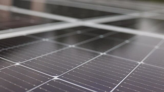 Close-up of modern photovoltaic solar battery panels. Ecology and environment protection concept. Renewable green energy. Solar panels close-up. Solar panels slow motion. Solar panels moving shot.