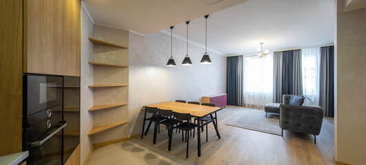 Modern interior of spacious light studio apartment. Wooden design.