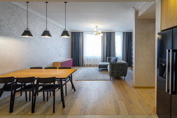 Modern interior of light living room in studio apartment with furniture.