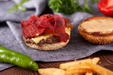 Bacon burger, caramelized onions and french fries.