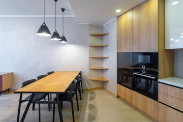 Modern interior of spacious light wooden kitchen in apartment.