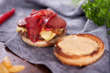 Bacon burger, caramelized onions and french fries.