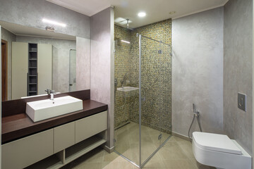 Fototapeta na wymiar Modern interior of luxury bathroom. Wooden counter. Marble walls.
