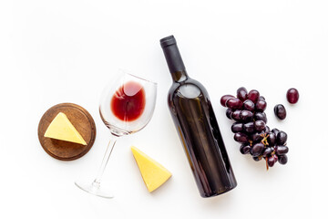 Red wine glasse and bottle with bunch of grape