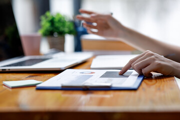 Close up of hand,Financial Businesswomen analyze the graph of the company's performance to create...