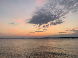 Fototapeta premium dawn over the Volga river, water and cloudy sky