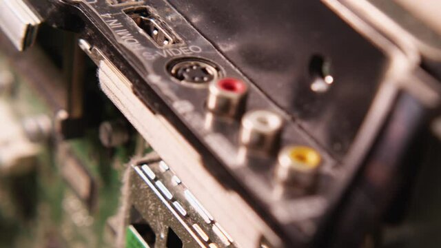 Dusty TV side panel with different inputs: hdmi, TV input, pcmcia, s-video, usb. Electronics repair shop. Close-up